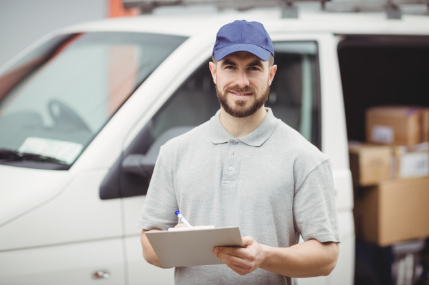delivery-man-writing-clipboard-front-his-van